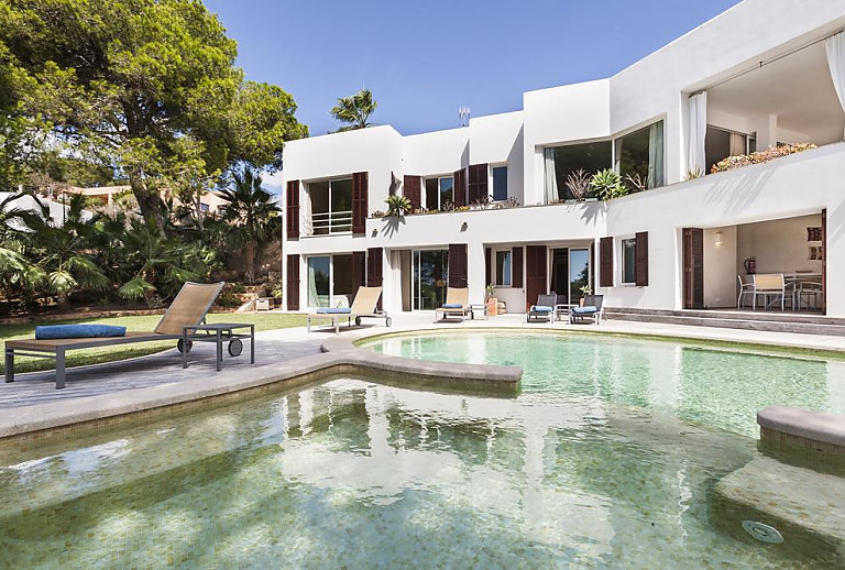 Sonnenliegen am Pool vor dem Ferienhaus